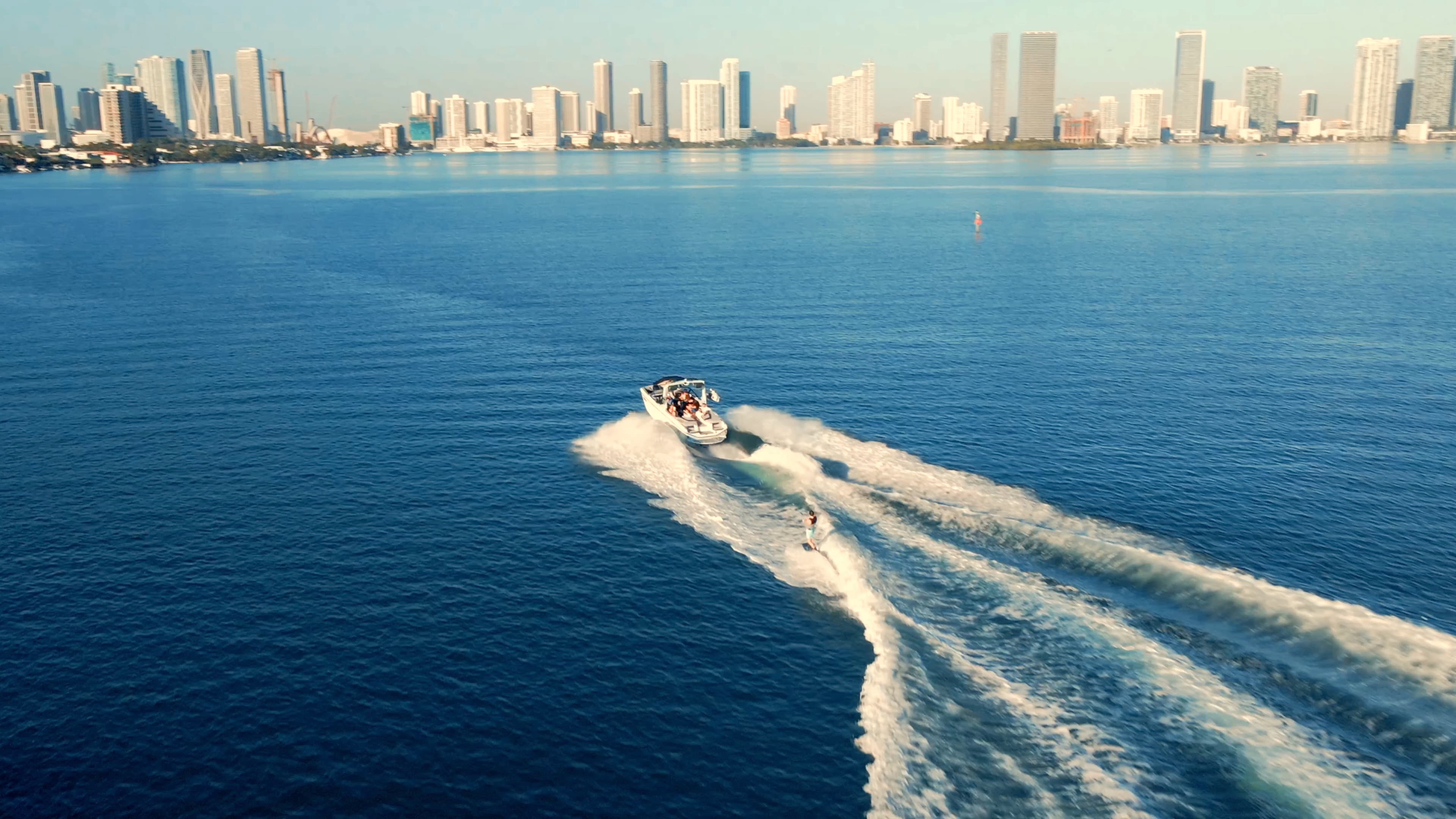 WakeXscape rider creating water spray behind the boat
